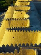 ancient yellow city wall with battlements, Uzbekistan, khiva