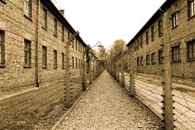 wire fenced path along buildings in auschwitz concentration camp, Holocaust memorial, poland, krakow