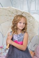 pretty child girl with white umbrella in studio, portrait