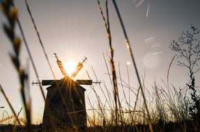 old windmill at sunset sky