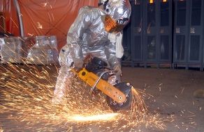 construction worker sawing metal
