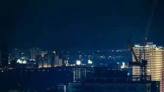 night cityscape with metro station under construction