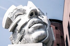 dead man’s face at sky, modern stone sculpture, monument to soldier