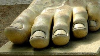 bare foot of stone sculpture close up