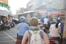 woman with backpack in asian city