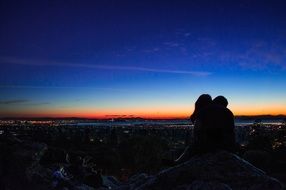 silhouette of kissing couple at dusk