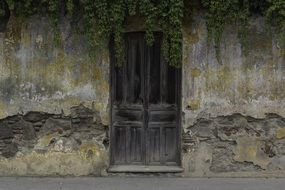 ancient facade and wood door of old house in Guatemala in Central America
