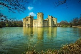 bodiam castle with mirroring on water at winter, uk, england