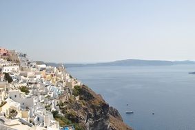 white town on mountain at sea, greece