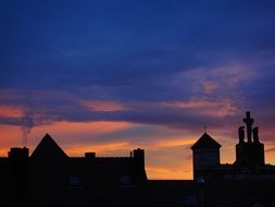roofs of city houses at evening sky