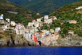 colorful houses on mountain at blue sea, italy, cinque terre, riomaggiore