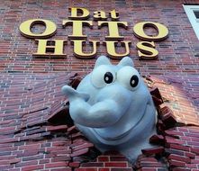 fantasy animal head and letters on brick facade, otto waalkes birthplace, germany, Emden