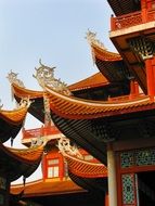 fragment of buddhist temple red roof at blue sky, china, fuzhou