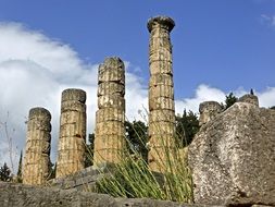 ruins roman ancient rock columns clouds blue sky view