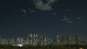 high rise residential buildings at night sky