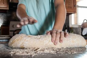 woman making bread at home on kitchen