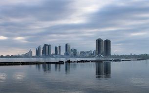 waterfront of city on lake at cloudy morning, canada, toronto