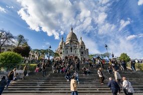 The staircase is filled with people near the cathedral in paris