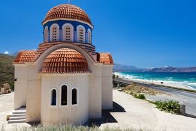 orthodox church with clay tile roof at sea, greece, crete