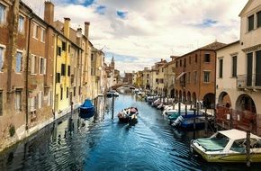 Photo of waterway with boats in Italy