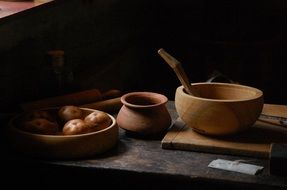 vintage wooden pots on kitchen table