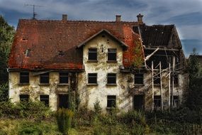 old ruined house with red tile roof