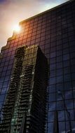skyscraper facade with reflexion of grey building at sunset, canada, toronto