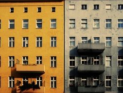 contrasting buildings, yellow and grey facades with balconies