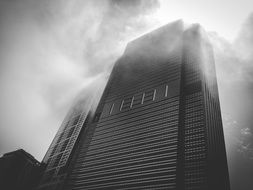 top of modern building in fog at sky