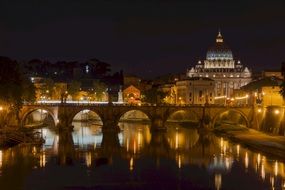 bridge, saint peters basilica and sant'angelo castle at nigh, italy, rome
