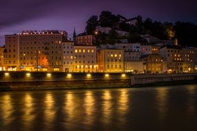 night cityscape with salzach river, austria, salzburg