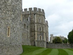 medieval windsor castle walls at cloudy sky, uk, england, london