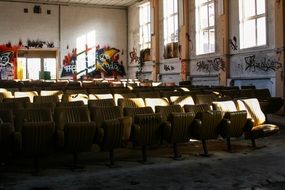 rows of seats in dirty interior of old abandoned cinema