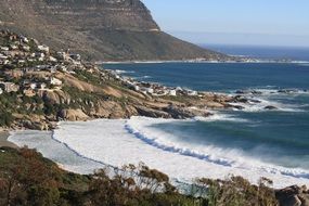 foamy ocean waves at rocky coast, south africa, cape town