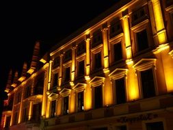 illuminated facade of old building at night, poland