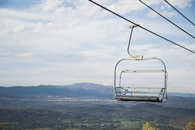 free chairlift on cabway in aerial view of mountains