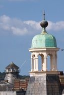 old green copper dome on arched columnar at sky, england