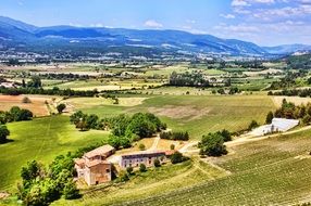 fields and buildings in countryside at mountains, france, provence