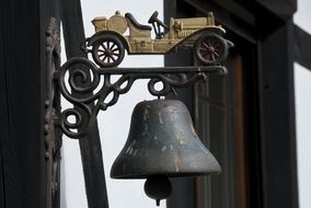 vintage cast iron door bell with forged car at top