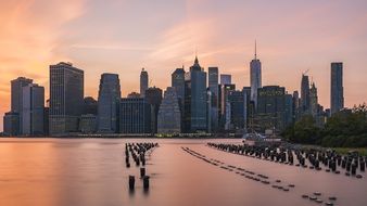 new york city waterfront with pink sky mirroring, usa, manhattan