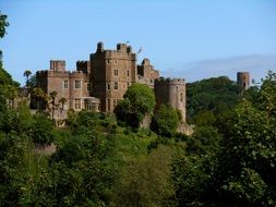 Dunster castle in green trees