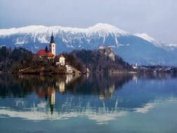 castle in forest at snow-capped mountains on landscape, slovenia, Bled Island