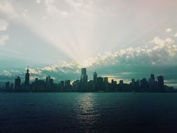 sunbeams burst through clouds above city skyline, usa, Illinois, chicago