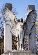 winged woman, stone sculpture on cemetery