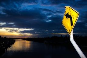 night view river cloudy sky traffic sign