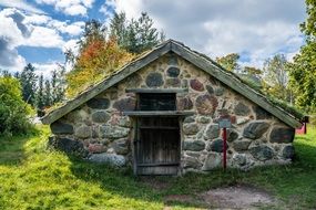 traditional stone house in autumn park, sweden, skansen