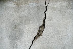 crack on grey concrete wall, texture