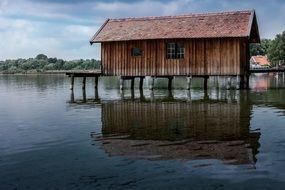 wooden boat house on ammersee lake, germany, bavaria