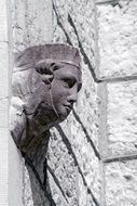 stone carved female head on wall
