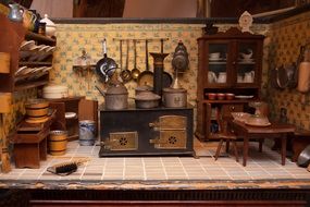 kitchen of antique dolls house, interior with stove, furniture and kitchenware